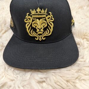 JC Black and Gold Lion Crest Snapback Cap